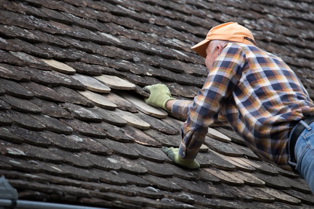 roof tech inspecting shingles on a roof