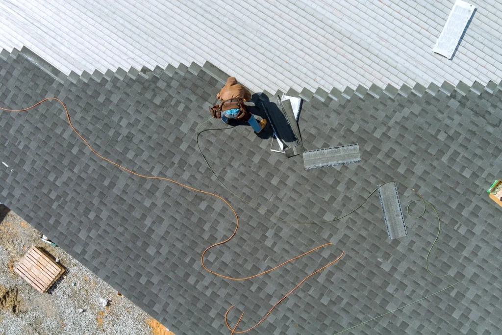 arial view of a roof tech installing shingles on a roof