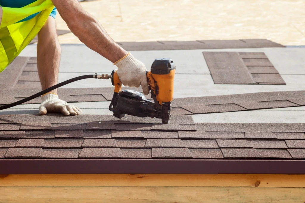 roofing materials being installed on a roof by a roof tech with power tools