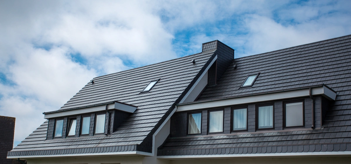steep sloping roof with new black shingles