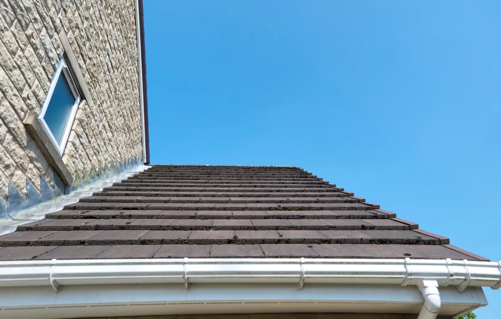 how old is roof-close up looking from gutters up towards the peak of a roof