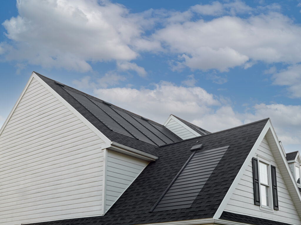 Gaf solar shingles on white residential house