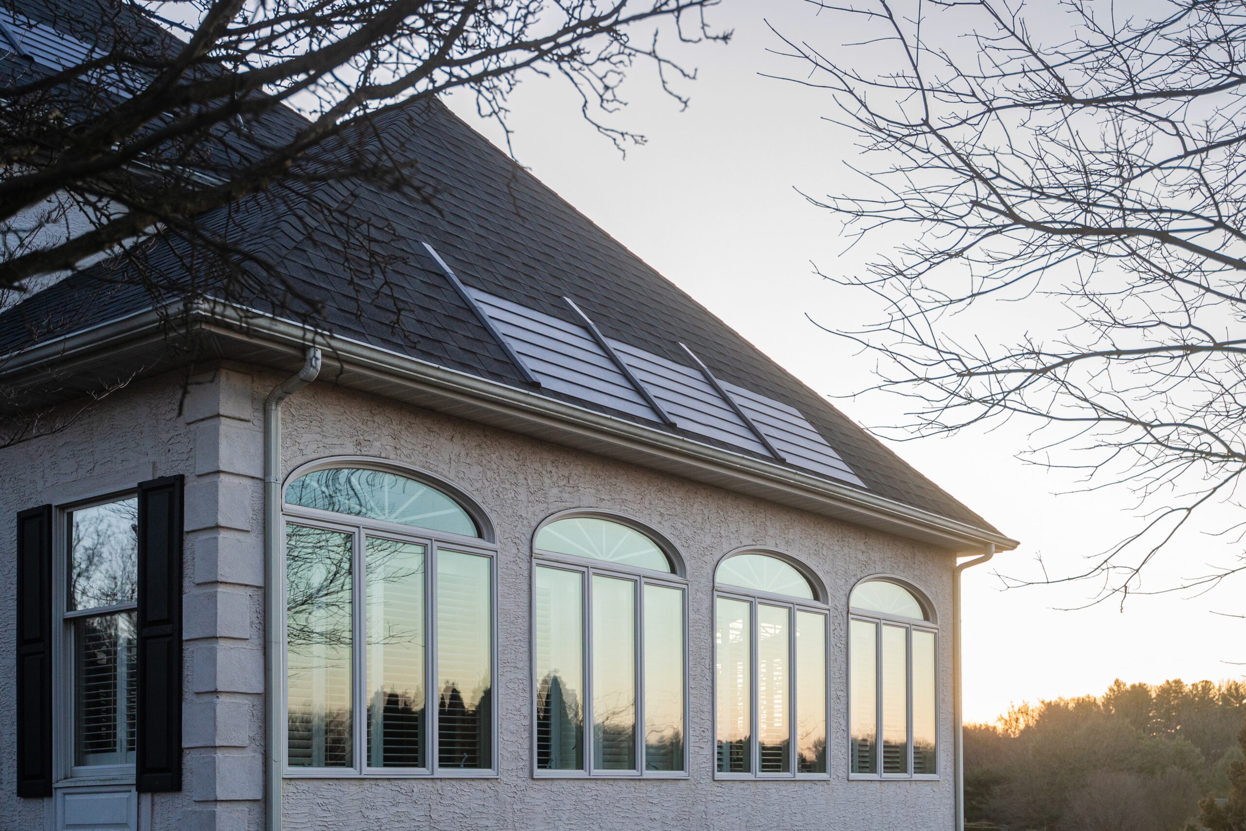 residential house with large windows and solar shingles